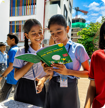 Students reading a Fin Edu Quest book